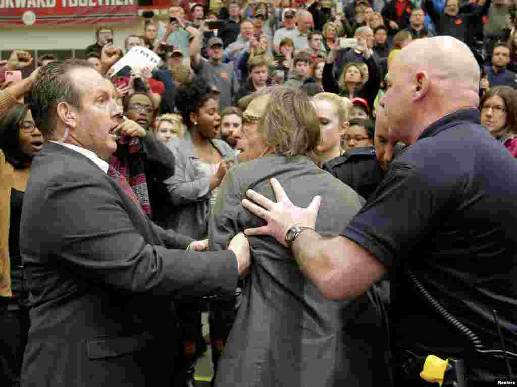 Photographer Christopher Morris is removed by security officials as U.S. Republican presidential candidate Donald Trump speaks during a campaign event in Radford, Virginia, Feb. 29, 2016.