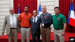 French President Francoise Hollande awarded the Legion of Honor medal on U.S. Airman Spencer Stone, National Guardsman Alek Skarlatos, and their years-long friend Anthony Sadler, who subdued the gunman as he moved through the train with an assault rifle strapped to his bare chest. The British businessman, Chris Norman, also jumped into the fray. (AP Photo/Michel Euler, Pool)