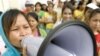 A Cambodian garment worker speaks on a loud speaker as she leads a strike in front of a factory on the outskirts of Phnom Penh, Cambodia, Monday, Sept. 13, 2010. 