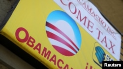 FILE - A sign on an insurance store advertises Obamacare in San Ysidro, San Diego, California, U.S.