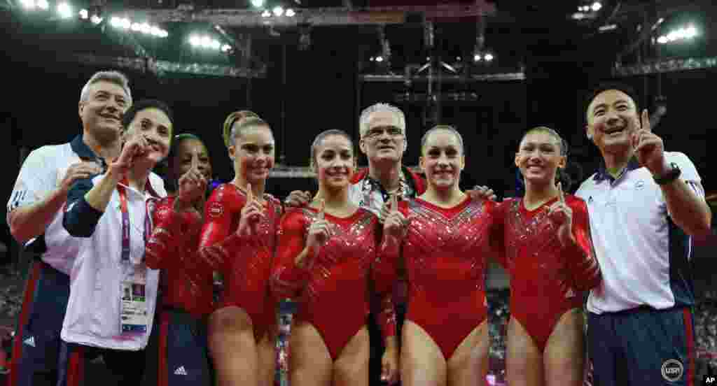 US gymnasts celebrate gold medal win with coaches after women's team final at 2012 Summer Olympics, July 31, 2012