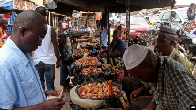 Food prices have shot up in the three countries most affected by Ebola, including Guinea. A customer shops at a market in its capital, Conakry, Aug. 15, 2014.