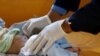 FILE - A nurse checks a boy at a cholera treatment center at the al-Sabeen hospital in Sanaa, Yemen, Oct. 3, 2018. 