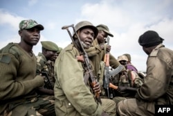 Soldiers of the Armed Forces of the Democratic Republic of the Congo (FARDC) prepare to escort health workers attached to ebola response programs on May 18, 2019 in Butembo, north of Kivu.