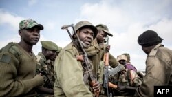 FILE - Soldiers of the Armed Forces of the Democratic Republic of the Congo (FARDC) prepare to escort health workers attached to ebola response programs in Butembo, north of Kivu, May 18, 2019.