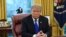 FILE - President Donald Trump is seen at his desk in the Oval Office of the White House, in Washington, Feb. 22, 2019. 