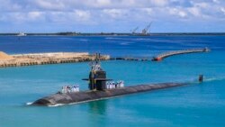 FILE - A fast-attack submarine returns to the U.S. naval base in Guam, Aug. 19, 2021, in this photo provided by U.S. Navy.