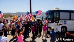 Demonstrators block the buses carrying the undocumented, who were scheduled to be processed at the Murrieta Border Patrol Station in Murrieta, California, July 1, 2014. 