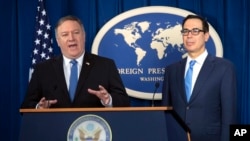 Secretary of State Mike Pompeo, left, and Treasury Secretary Steven Mnuchin, present details of the new sanctions on Iran, at the Foreign Press Center in Washington, Monday, Nov. 5, 2018. (AP Photo/J. Scott Applewhite)