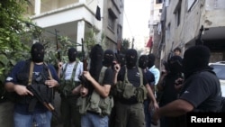 Shi'ite masked gunmen from the Meqdad clan, gather at the Meqdad family's association headquarters in the southern suburbs in Beirut, Lebanon, August 15, 2012.