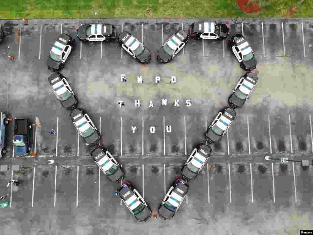 The Fort Myers Police Department makes heart out of police cars to thank health workers at Lee Memorial Hospital, in Fort Myers, Florida, in this picture obtained from social media.