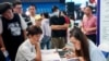 FILE - University graduates attend a job fair in Wuhan, in China's central Hubei province, Aug. 10, 2023. 