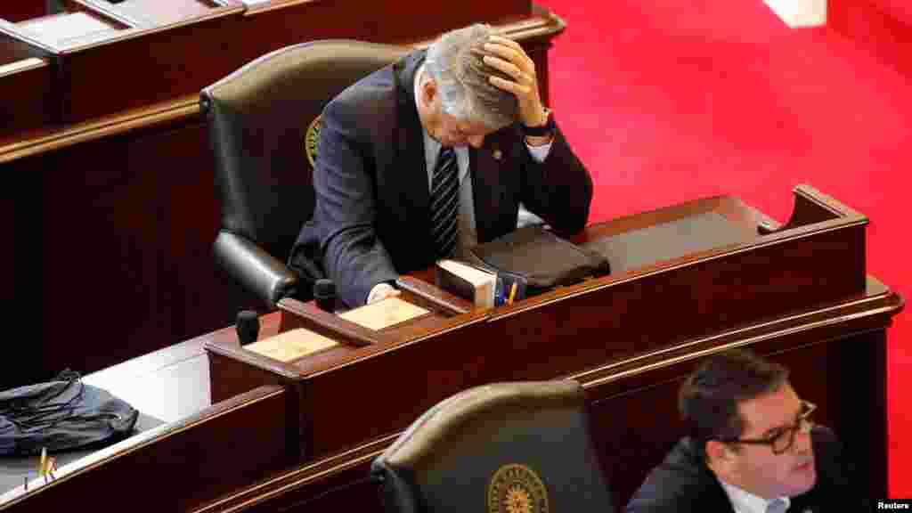 Republican State Senator Norman Sanderson holds his head while fellow Republican Senator Andrew Brock (R) looks during a failed attempt to repeal the controversial HB2 law limiting bathroom access for transgender people in Raleigh, North Carolina, USA, Dec. 21, 2016.