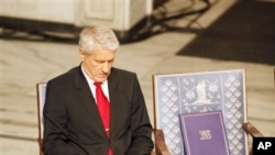 Nobel committee chairman Thorbjorn Jagland sits next to an empty chair with the Nobel medal and diploma for Nobel Peace Prize laureate Liu Xiaobo during a ceremony honoring Liu at city hall in Oslo, Norway Dec. 10, 2010.