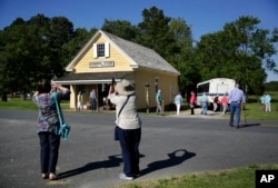 Tourists photograph the Bucktown Village Store, a rural store building that has been restored on the spot believed to be where Harriet Tubman refused a slave owner's orders to help him detain a fellow slave, in Bucktown, Md.