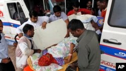 A patient is shifted to an ambulance after the hospital she was being treated in had to be shut down because of a power failure amid flooding in Chennai, in the southern Indian state of Tamil Nadu, Dec. 4, 2015.