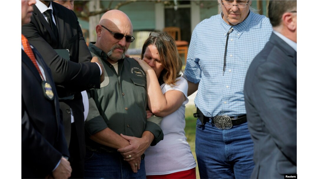 Pastor Frank Pomeroy, with his wife Sherri, listens at a news conference outside the site of the shooting at his church, the First Baptist Church of Sutherland, Texas, Nov. 6, 2017.