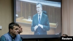 Viktor Yanukovych gives evidence via a video link seen on a courtroom screen in Kyiv, Ukraine, Monday, Nov. 28, 2016. The former president testified during the trial of former police officers suspected of killing protesters during the Maidan street revolt in 2014.