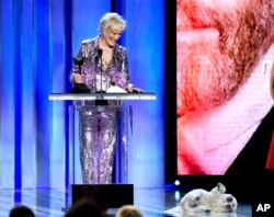Glenn Close, winner of the award for best female lead for "The Wife," reacts as her dog, Sir Pippin of Beanfield, rolls onstage at the 34th Film Independent Spirit Awards, Feb. 23, 2019, in Santa Monica, Calif.