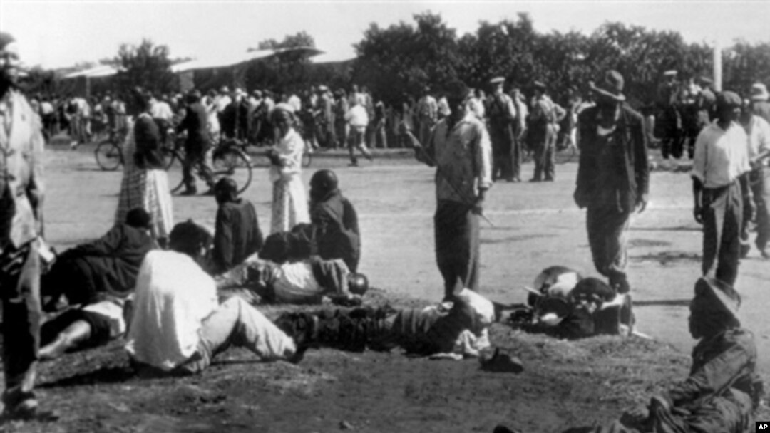 Wounded people lie in the street in Sharpeville, near Vereeniging, where at least 180 black Africans, most of them women and children, were injured and 69 killed, when South African police opened fire on black protesters, 21 Mar 1960