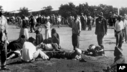 Wounded people lie in the street in Sharpeville, near Vereeniging, where at least 180 black Africans, most of them women and children, were injured and 69 killed, when South African police opened fire on black protesters, 21 Mar 1960