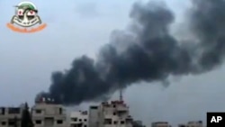 This image made from citizen journalist video posted by the Shaam News Network, which has been verified and is consistent with other AP reporting, shows smoke from shelling in the countryside of Damascus, Syria, Nov. 6, 2013.
