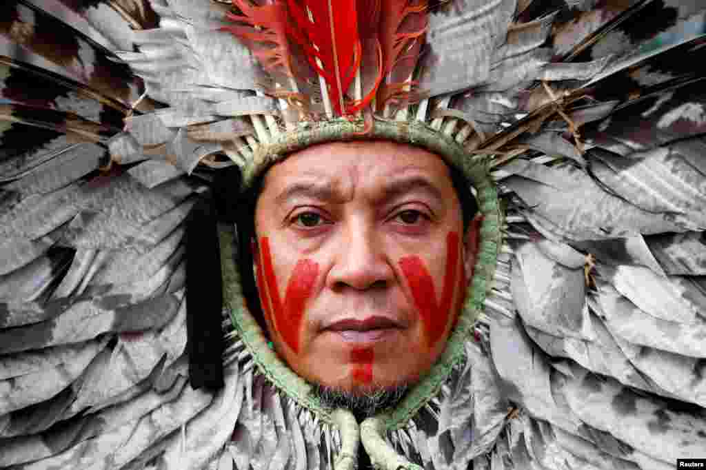 A Brazilian indigenous community leader takes part in a protest against the destruction of the Amazon forest, outside the European Commission headquarters, in Brussels, Belgium.