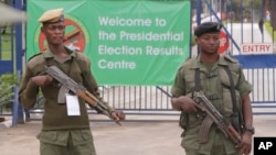 FILE - Armed police officers stand guard outside the presidential election results center in Lusaka, Zambia, Jan, 21, 2015.