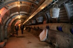 People walk inside an ancient tunnel during the opening of an ancient road at the City of David. The site is on what many believe to be the ruins of the biblical King David's ancient capital and see as centerpieces of ancient Jewish civilization.