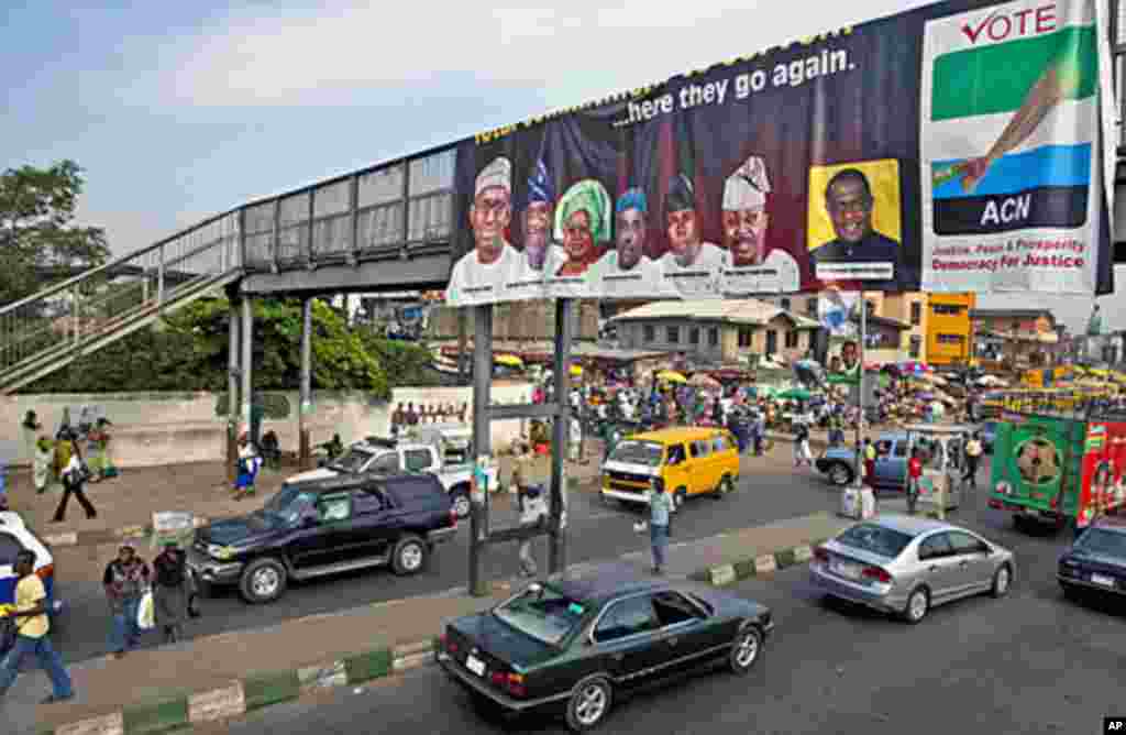 An election banner hangs on a pedestrian bridge in Mushin Neighbourhood in Nigeria's commercial capital Lagos, March 23, 2011. (Reuters Image)