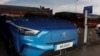 FILE - An EV from MG, a brand of Chinese state-owned carmaker SAIC, is seen through the glass of a car showroom in Santander, Spain, June 13, 2024.