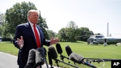 FILE - President Donald Trump talks to reporters on the South Lawn of the White House.