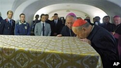 Archbishop of Kraków, and former John Paul II's secretary Stanislaw Dziwisz (r) kisses the coffin of late Pope John Paul II ahead of the beatification ceremony, April 29, 2011