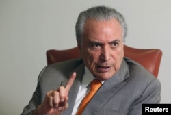 FILE - Brazil's President Michel Temer, gestures during an interview with Reuters at his office in Brasilia, Brazil, Jan. 16, 2017.