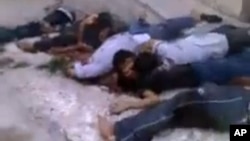 Human Rights Watch says these Syrians were killed execution-style in the village of al-Bayda May 3, 2013. Amateur video via AP.