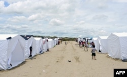 Hundreds of people from small villages close to the city of Piura, in northern Peru, are gathering in temporary camps, March 31, 2017, where they receive shelter, food and medical care.