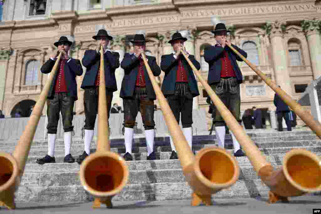 Bavarian musicians from Engetried play traditional horns in St. Peter&#39;s Square before the pope&#39;s weekly general audience at the Vatican.