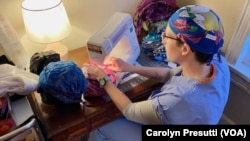 “Gi” sews healthcare scrub caps as part of her recovery from a panic attack and PTSD. She has moved from an emergency room nurse to a hospice unit. (Carolyn Presutti/VOA)