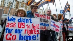 Người dân cầm những tấm bảng chống Mỹ tập trung trước cửa Đại sứ quán Hoa Kỳ ở Moscow để biểu tình, ngày 7 tháng 3 năm 2015.