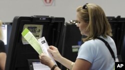 A voter checks her ballot during early voting in Miami, Florida