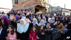 People gather outside the minority school where Turkey's President Recep Tayyip Erdogan was visiting in the northeastern Greek town of Komotini, Dec. 8, 2017.
