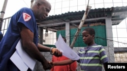 Moses Duo, 9, receives a certificate for being cured of the Ebola virus in Paynesville, Liberia, July 20, 2015. 