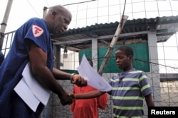 Moses Duo, 9, receives a certificate for being cured of the Ebola virus in Paynesville, Liberia, July 20, 2015.