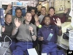 FILE - Astronauts David Brown, Ilan Ramon, Rick Husband, Kalpana Chawla, William McCool, Michael Anderson, and Laurel Clark, foreground, pose for a television camera aboard Columbia, Jan. 20, 2003.