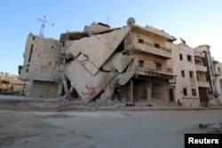 A damaged building is seen in Hraytan city, about 10 kilometers away from the towns of Nubul and Zahraa, Northern Aleppo countryside, Syria, Feb. 3, 2016.