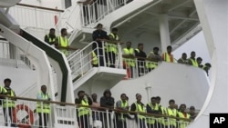 Bangladeshi immigrants evacuated from Libya are seen on the deck of the ferry 'Ionian King' docked inside Souda port in Crete, Greece, March 6, 2011