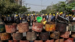 People build barricades to deter security personnel from entering a protest area in Mandalay, Myanmar, Thursday, March 4, 2021. (AP Photo)