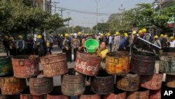 People build barricades to deter security personnel from entering a protest area in Mandalay, Myanmar, Thursday, March 4, 2021. (AP Photo)