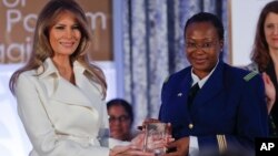 First lady Melania Trump presents the 2017 Secretary's of State's International Women of Courage (IWOC) Award to Major Aichatou Ousmane Issaka, from Niger, March 29, 2017, at the State Department in Washington.