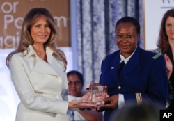 First lady Melania Trump presents the 2017 Secretary's of State's International Women of Courage (IWOC) Award to Major Aichatou Ousmane Issaka, from Niger, March 29, 2017, at the State Department in Washington.